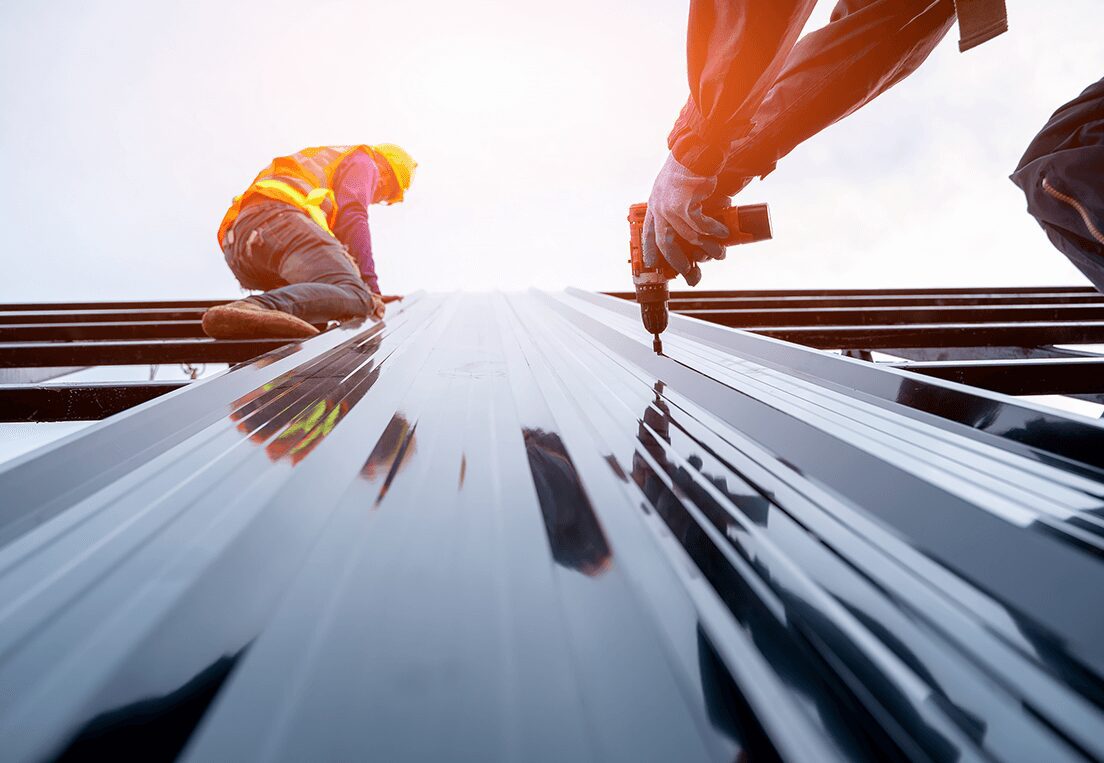 Two men installing metal sheeting