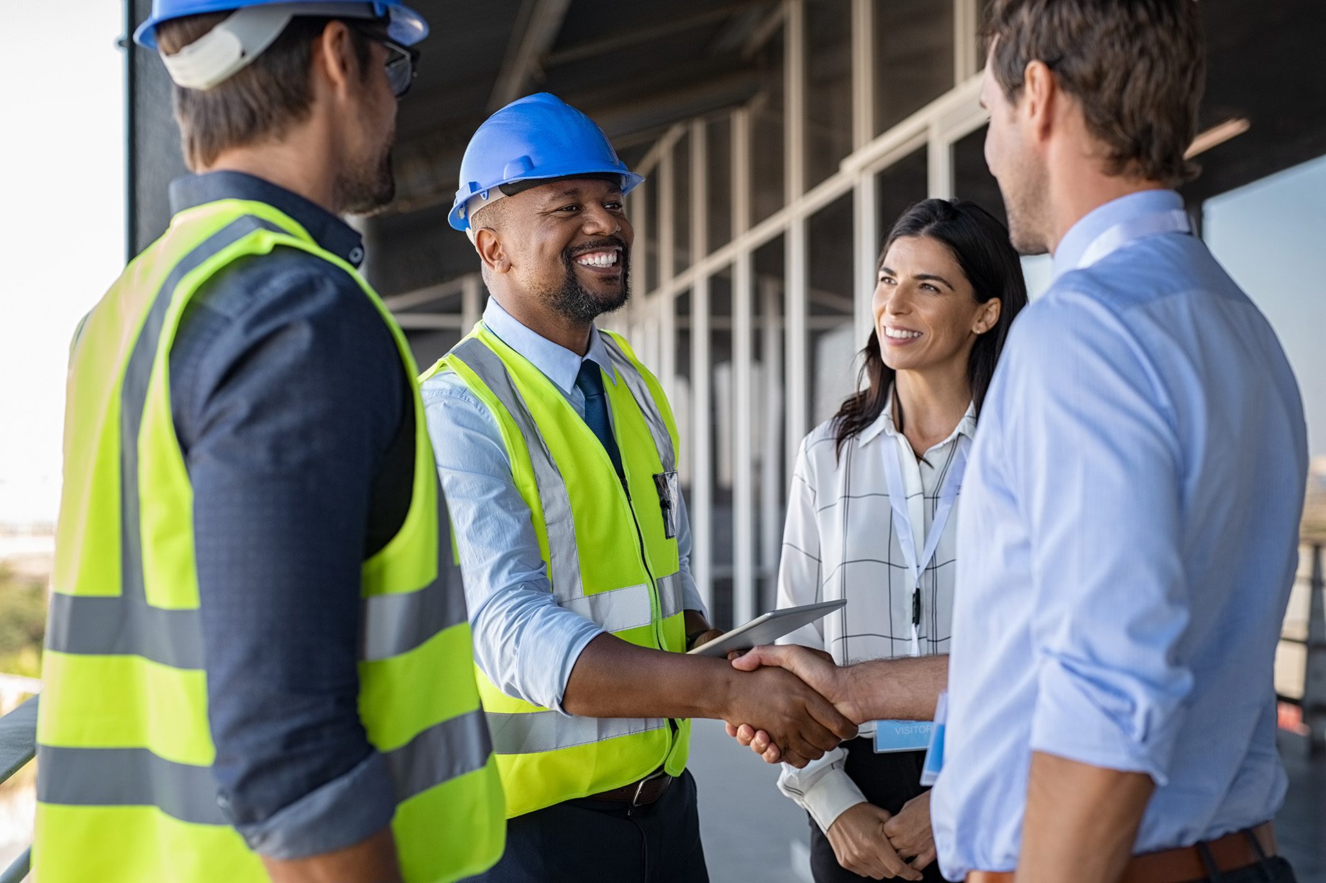 4 people shaking hands on the jobsite