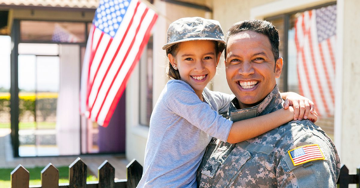 Veteran in uniform holding daughter