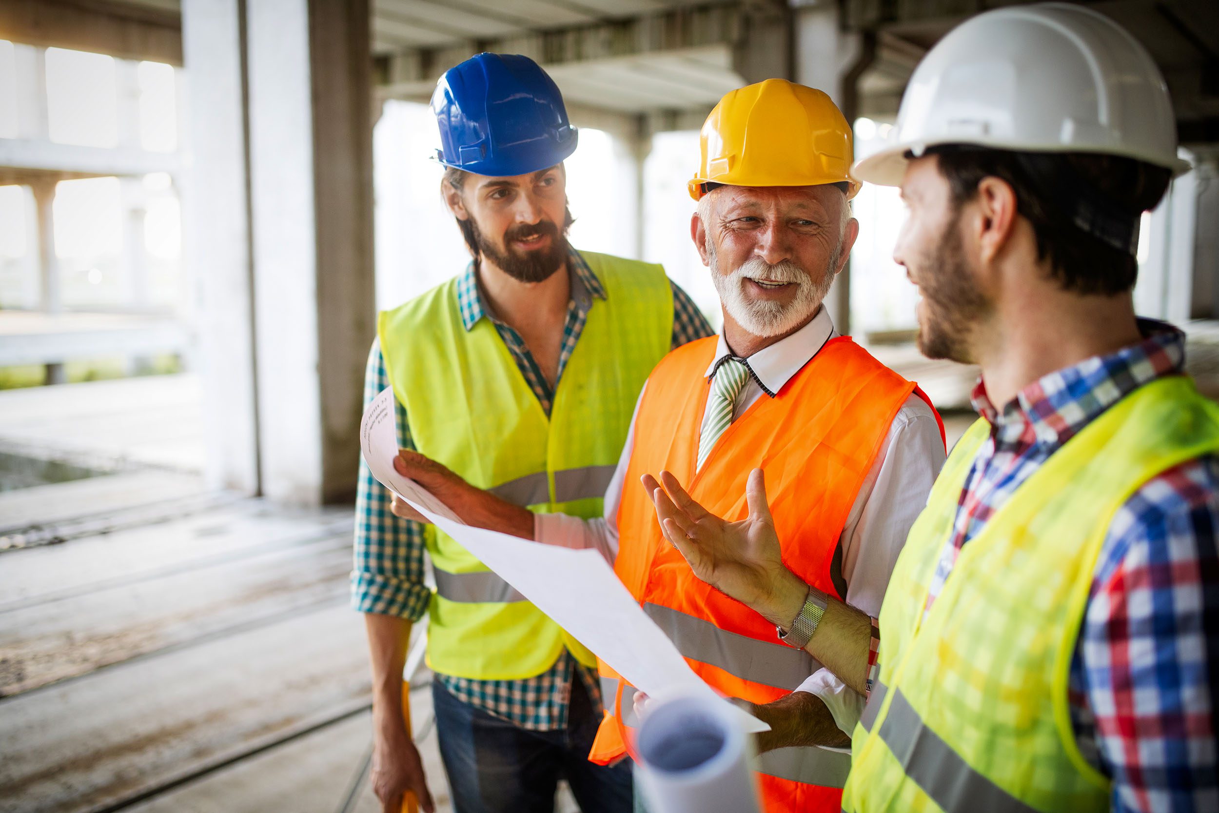 Construction Workers on Site Looking at Plans