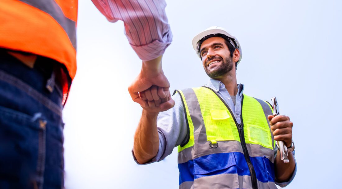 Construction Workers Fist Bump