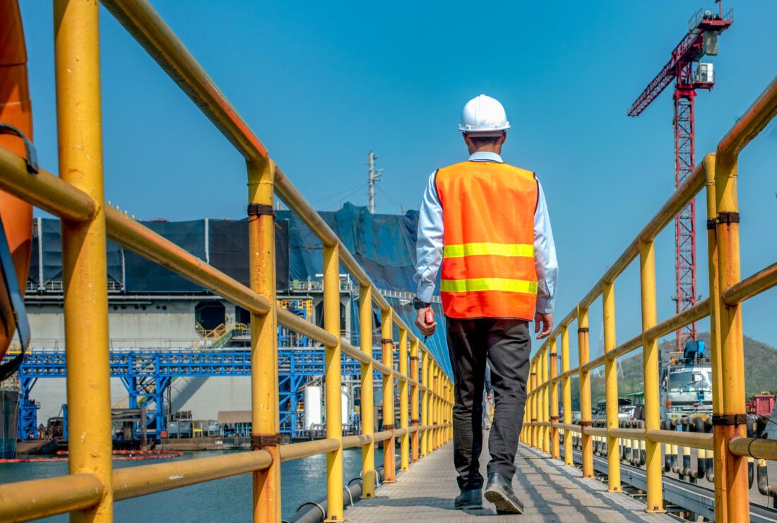 Man walking on guardrail passive fall protection system